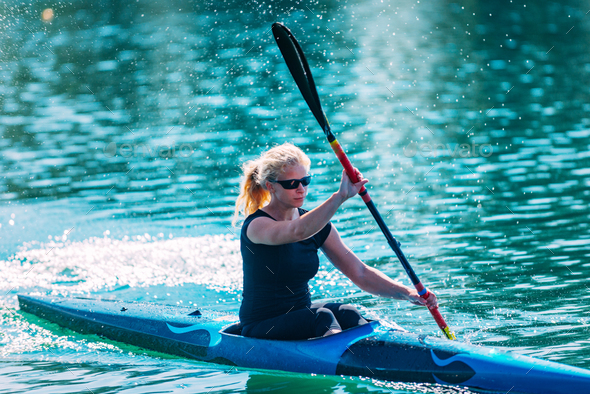 Female athlete in kayak Stock Photo by microgen | PhotoDune