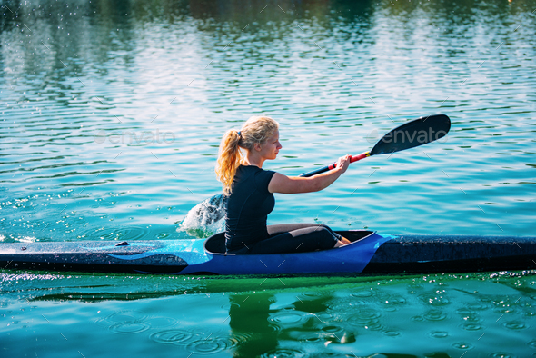 Female athlete in kayak Stock Photo by microgen | PhotoDune