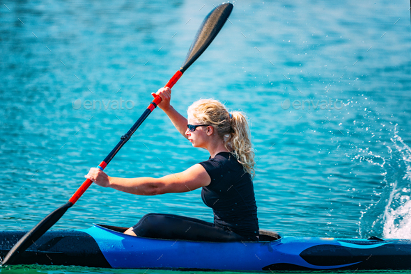 Female athlete in kayak Stock Photo by microgen | PhotoDune