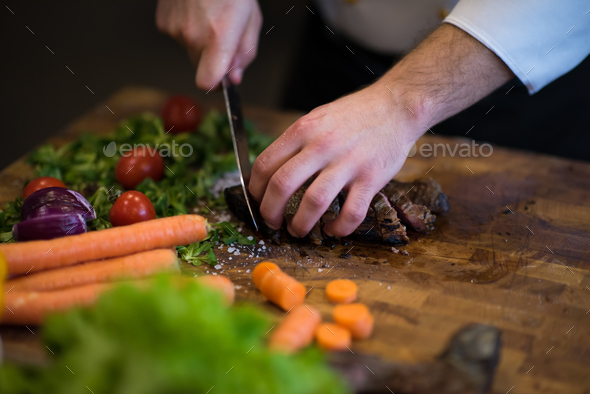 closeup of Chef hands preparing beef steak - Stock Photo - Images