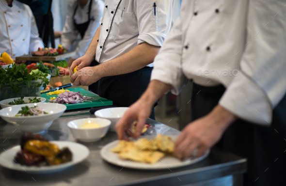 team cooks and chefs preparing meal - Stock Photo - Images