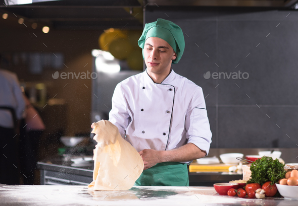 chef throwing up pizza dough - Stock Photo - Images