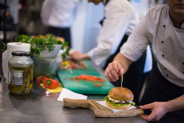 chef finishing burger - Stock Photo - Images