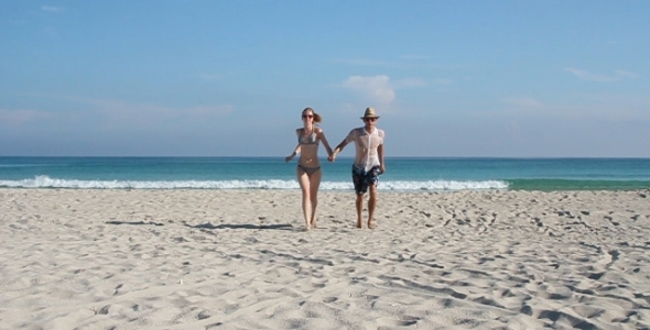 Couple Running On The Beach