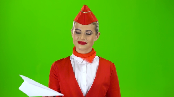 Girl Is Launching a Paper Airplane. Green Screen alt