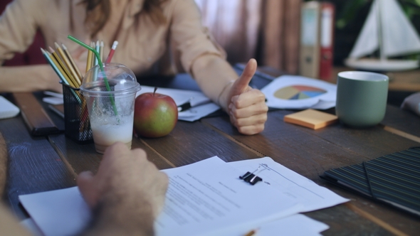Woman Boss Showing Thumbs Up on Table at Business Meeting alt