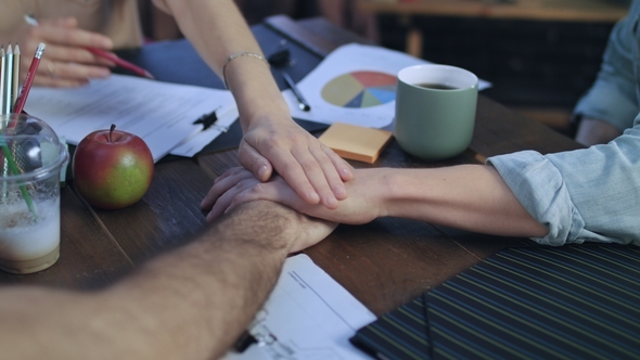 Business Men Putting Hands on Table To Connect with Team at Startup Meeting alt