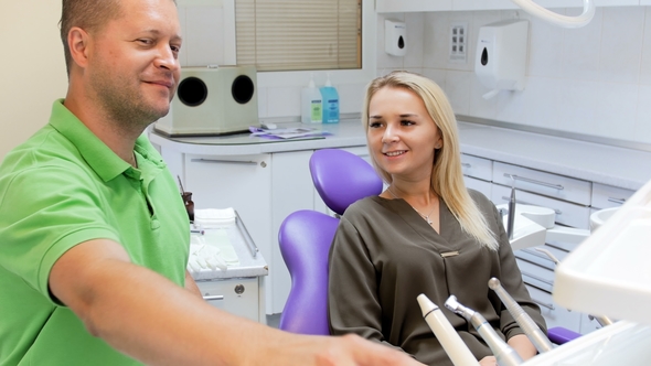 Smiling Dentist Shaking Hands with Happy Female Patient alt
