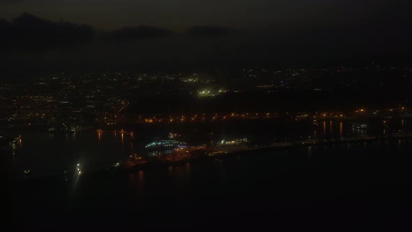 Approaching Barcelona airport at night. Lighted city line on the shore of the mediteranean sea. Shot alt