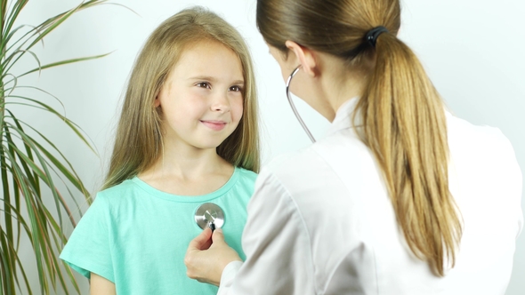 Cute Smiling Little Girl in Hospital. Doctor with Stethoscope Examining Young Girl