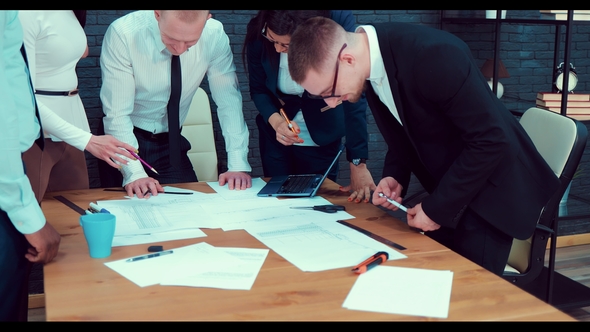Portrait of a Young Business Team at Work. Employees of the Construction Company Are Studying alt