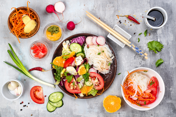 Spicy glass noodles with vegetables - carrots, cucumber, peppers, garlic. - Stock Photo - Images