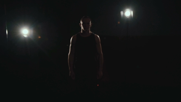 Hairless with Tattoos Free Fighter Comes and Speaks at Camera in the Darkness alt