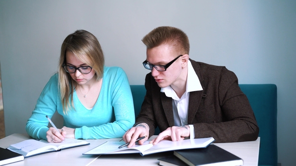 Portrait of Two Successful Students Casual Stylish, Boy and Girl in Library Reading Hall, Evening