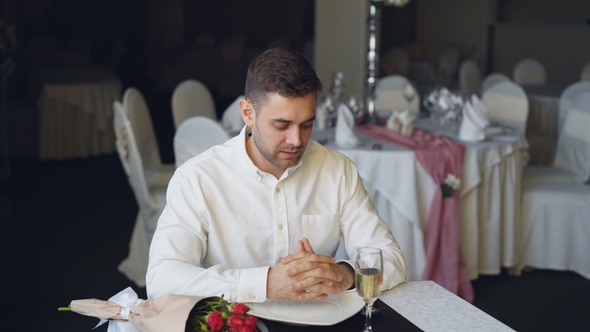 Loving Man Is Waiting for His Girlfriend in Restaurant, She Is Coming Closing His Eyes with Her alt