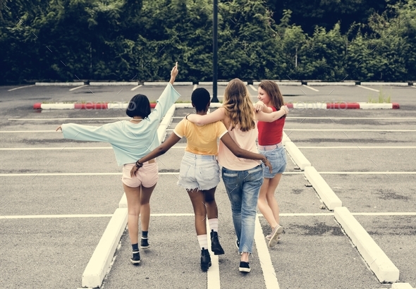 Rear view of a group of diverse woman friends walking together - Stock Photo - Images