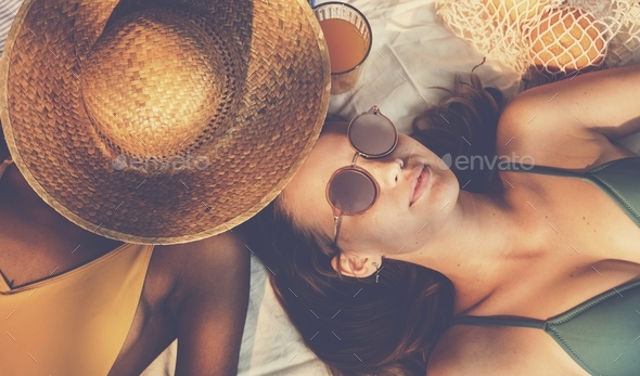 Cheerful girls in swimsuit sun tanning together Stock Photo by Rawpixel
