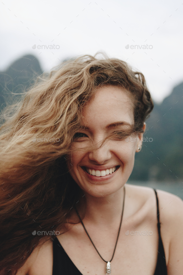 Portrait of a beautiful woman with curly hair - Stock Photo - Images