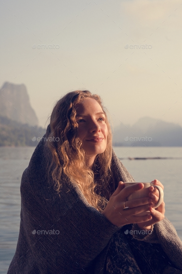 Woman warm in the morning sun - Stock Photo - Images