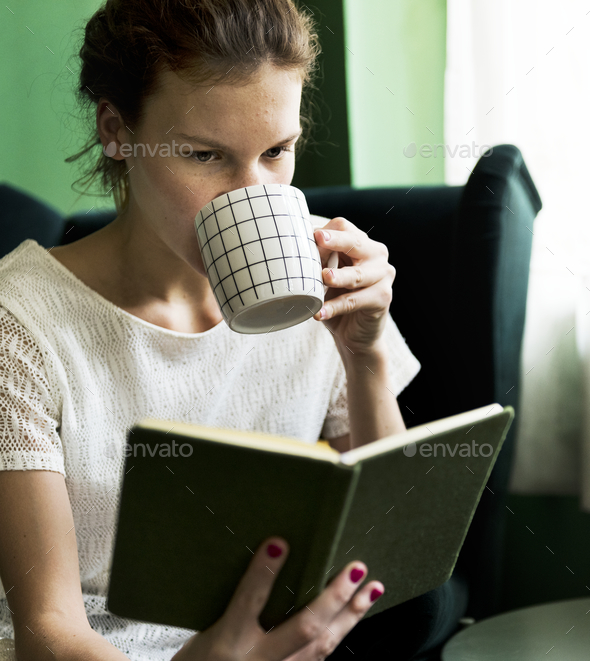 Girl reading a book at home - Stock Photo - Images