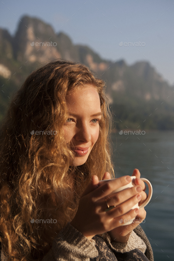 Woman warm in the morning sun - Stock Photo - Images