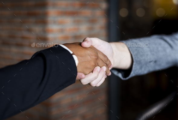 Businessmen shaking hands in a agreeement - Stock Photo - Images