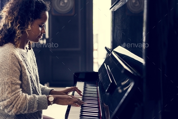 Woman playing on a piano - Stock Photo - Images