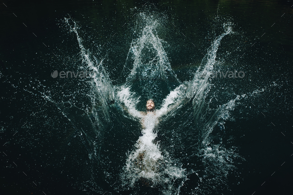 Man jumping into the water - Stock Photo - Images