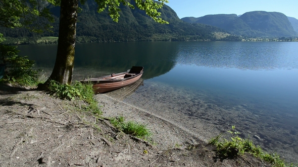 Small Boat in Idyllic Alpine Valley with Lake in Early Summer in Bohinj, Slovenia
