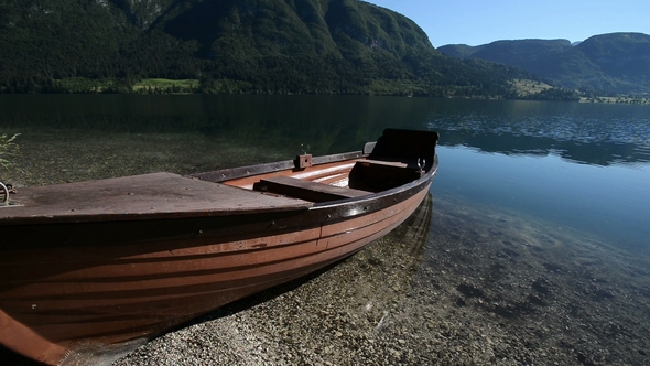 Small Boat in Idyllic Alpine Valley with Lake in Early Summer. Bohinj, Slovenia