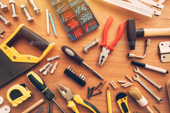 Assorted house renovation tools top view on workshop desk - Stock Photo - Images