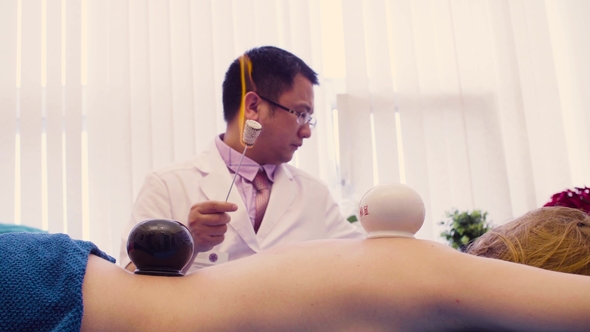 Chinese Therapist Doing Vacuum Massage
