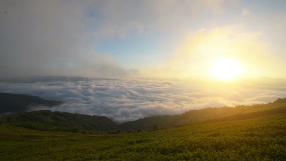 Brilliant Summit Dawn Above Flowing Cloud Waves, Red Sun Disk