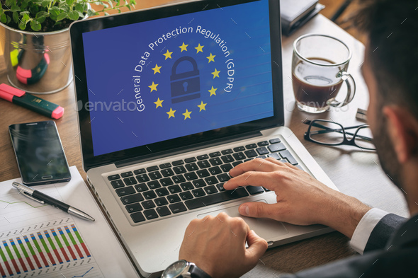 Man working with a computer, General Data Protection Regulation and European Union flag  - Stock Photo - Images