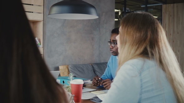 Panning Shot of Happy Multiethnic People Collaborating in Modern Trendy Office. Business Partners alt