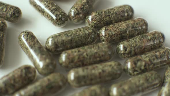 Herbal Medicine in Capsules with Cannabis Tree on Background for Healthy Eating Concept with Organic