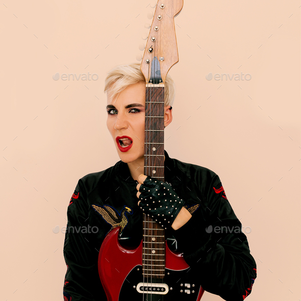 Tomboy fashion Model with electro guitar. Rock style Stock Photo by EvgeniyaPorechenskaya
