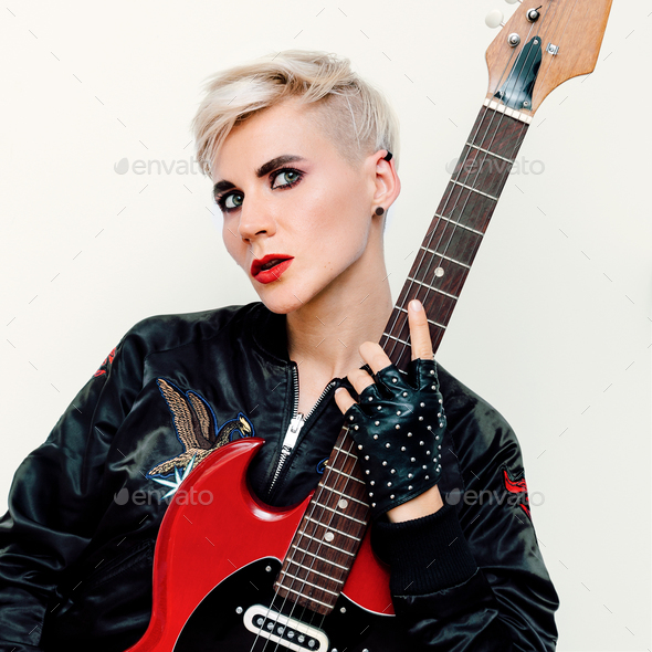Blond Model with electro guitar. Rock style fashion Stock Photo by EvgeniyaPorechenskaya