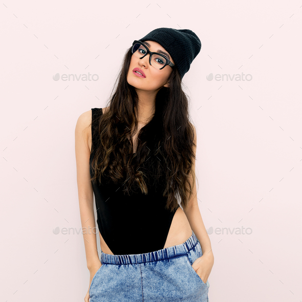 Stylish brunette in black body and beanie cap. Jeans. Tomboy sty Stock  Photo by EvgeniyaPorechenskaya