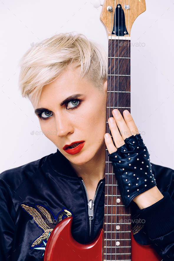 Sensual Blonde Girl with electro guitar. Rock style Stock Photo by EvgeniyaPorechenskaya