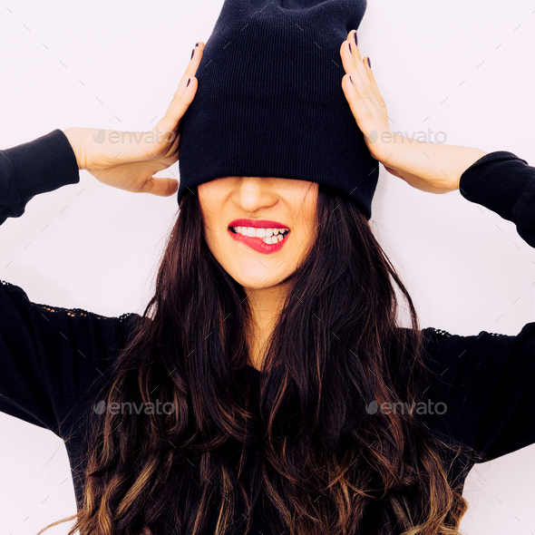 Playful brunette in fashionable black clothes. Urban style - Stock Photo - Images