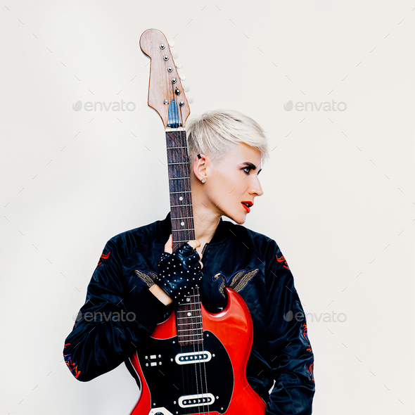 Blond girl with electro guitar. Rock style fashion Stock Photo by EvgeniyaPorechenskaya