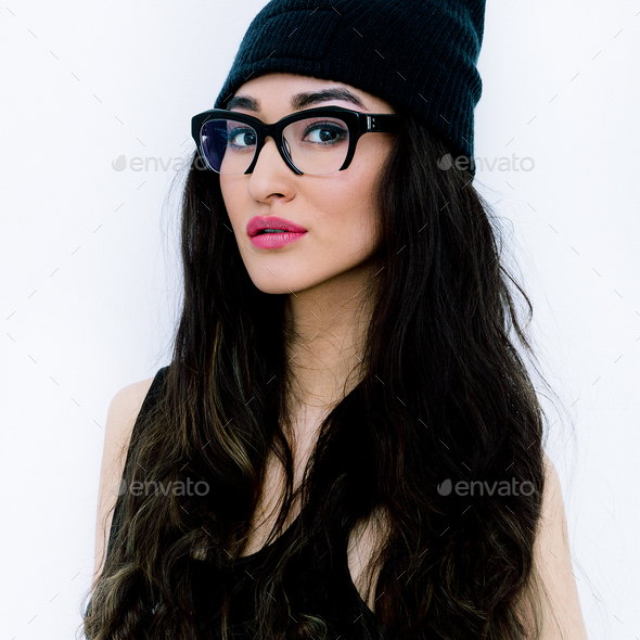Brunette Girl in stylish glasses and beanie cap - Stock Photo - Images