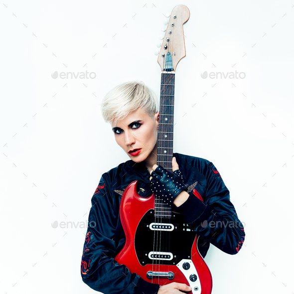 Blond Tomboy girl with electro guitar. Rock style fashion Stock Photo by EvgeniyaPorechenskaya