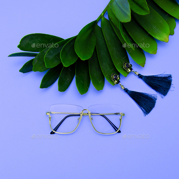 Glasses and Earrings. Stylish accessories for women. Flat lay - Stock Photo - Images