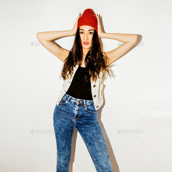 Brunette Pretty girl in fashion beanie cap and jeans. Urban casu - Stock Photo - Images