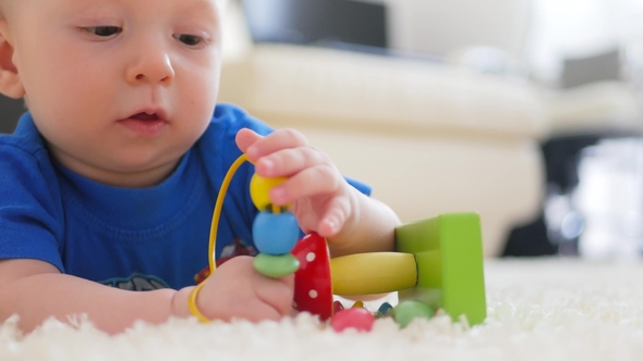 Funny Little Child Playing with Toys By the Home alt