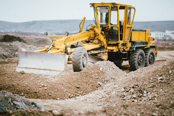 highway construction site with motor grader, excavator and bulldozer working