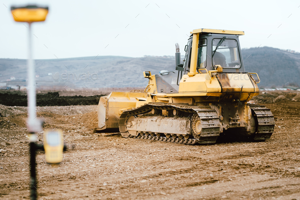 highway and road construction site with motor grader, excavator and bulldozer working Stock Photo by stockcentral