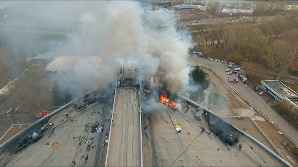 Aerial View of the Brave Firefighters Extinguish a Large Fire on the Roof of the Building